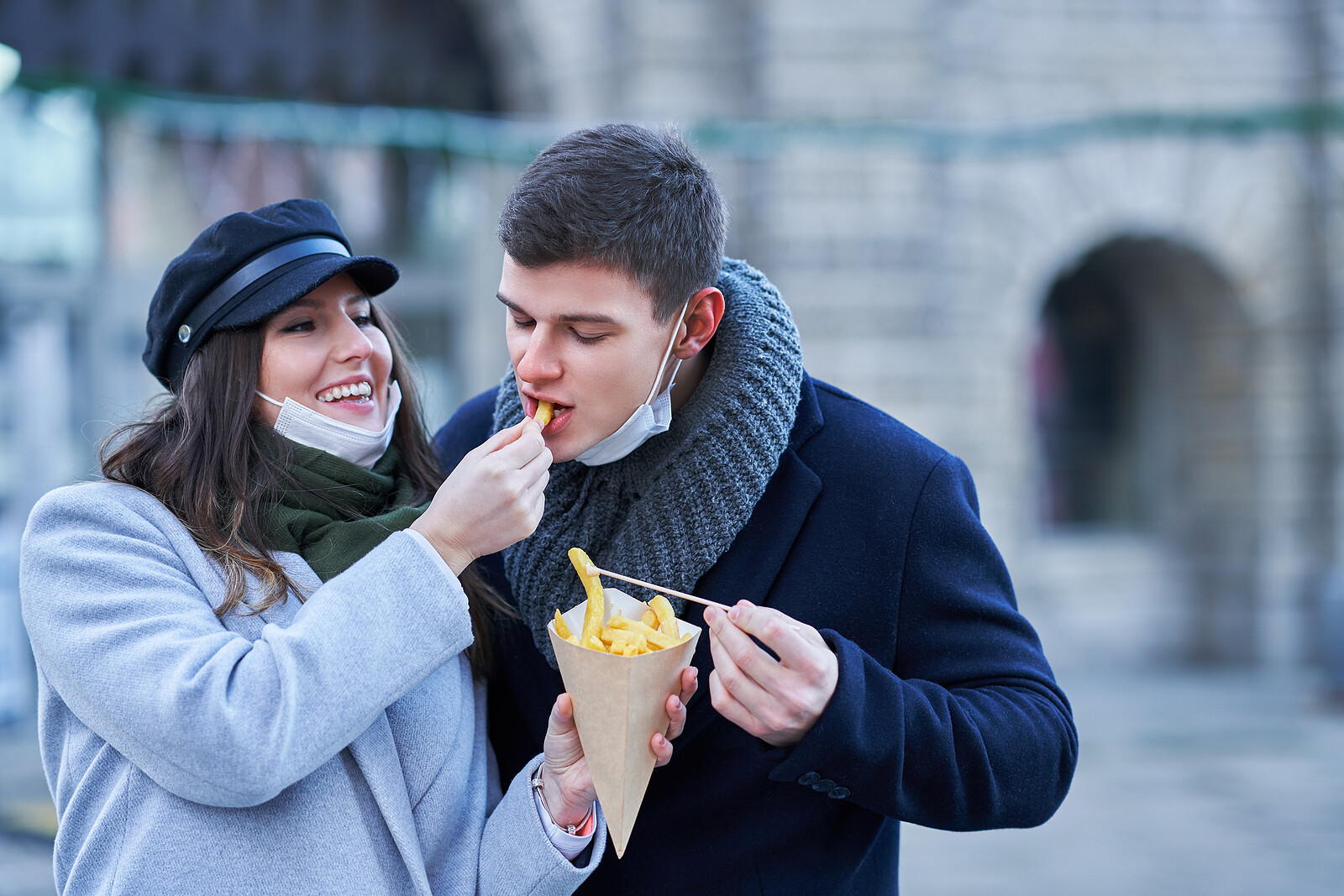 Happy couple celebrating Valentines Day in masks during covid-19