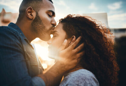 Shot of an affectionate young couple bonding together outdoors intimacy