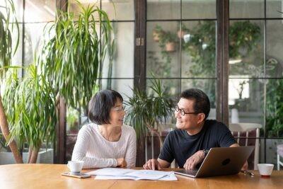Asian couple talking about money and buying a new house.