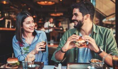 Happy loving couple enjoying breakfast date in a cafe. Love, dating, food, lifestyle concept