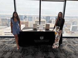 Two Maclynn matchmakers at their promotional stand at an event