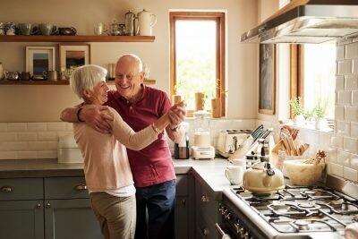 Cropped shot of a senior couple dancing in the kitchen at home