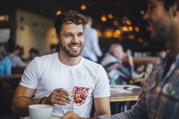 Two Friends Talking in a Cafe