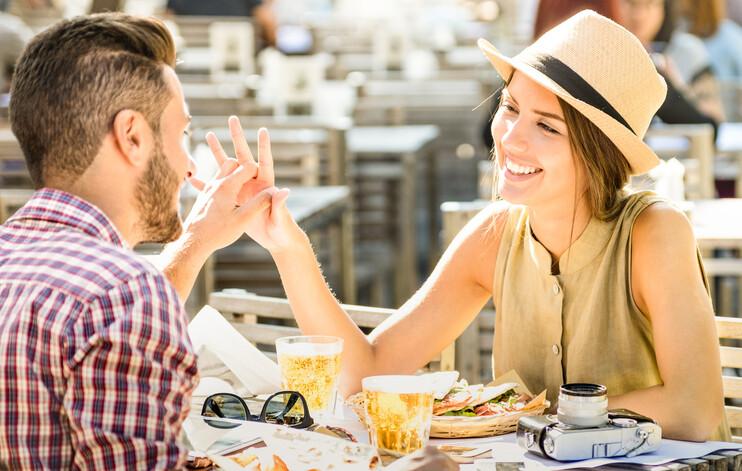 Couple on a date smiling, holding hands