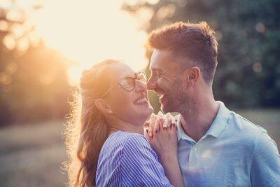 It is sunny day in late summer or early autumn, families using their free time to go to nature or city parks. Relaxed parenting and bonding with children while doing outdoor activities is great thing for parents with an age gap