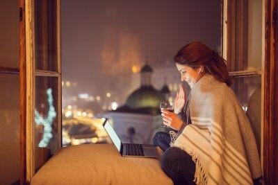 Smiling woman waving with hand on online video call