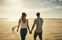 a couple walking by the beach in California