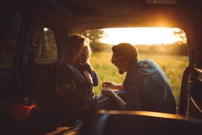 Man proposing his girlfriend in the car and popping the question
