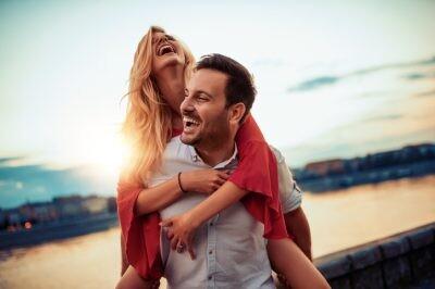 Happy young couple having fun outdoors enjoying love life