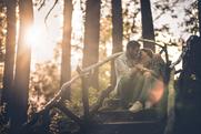 Young loving couple sitting on staircase in nature and enjoying in their love at sunset.